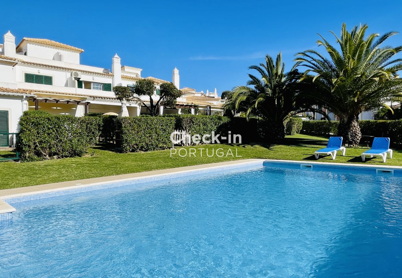 Pool exterior with garden and sun loungers