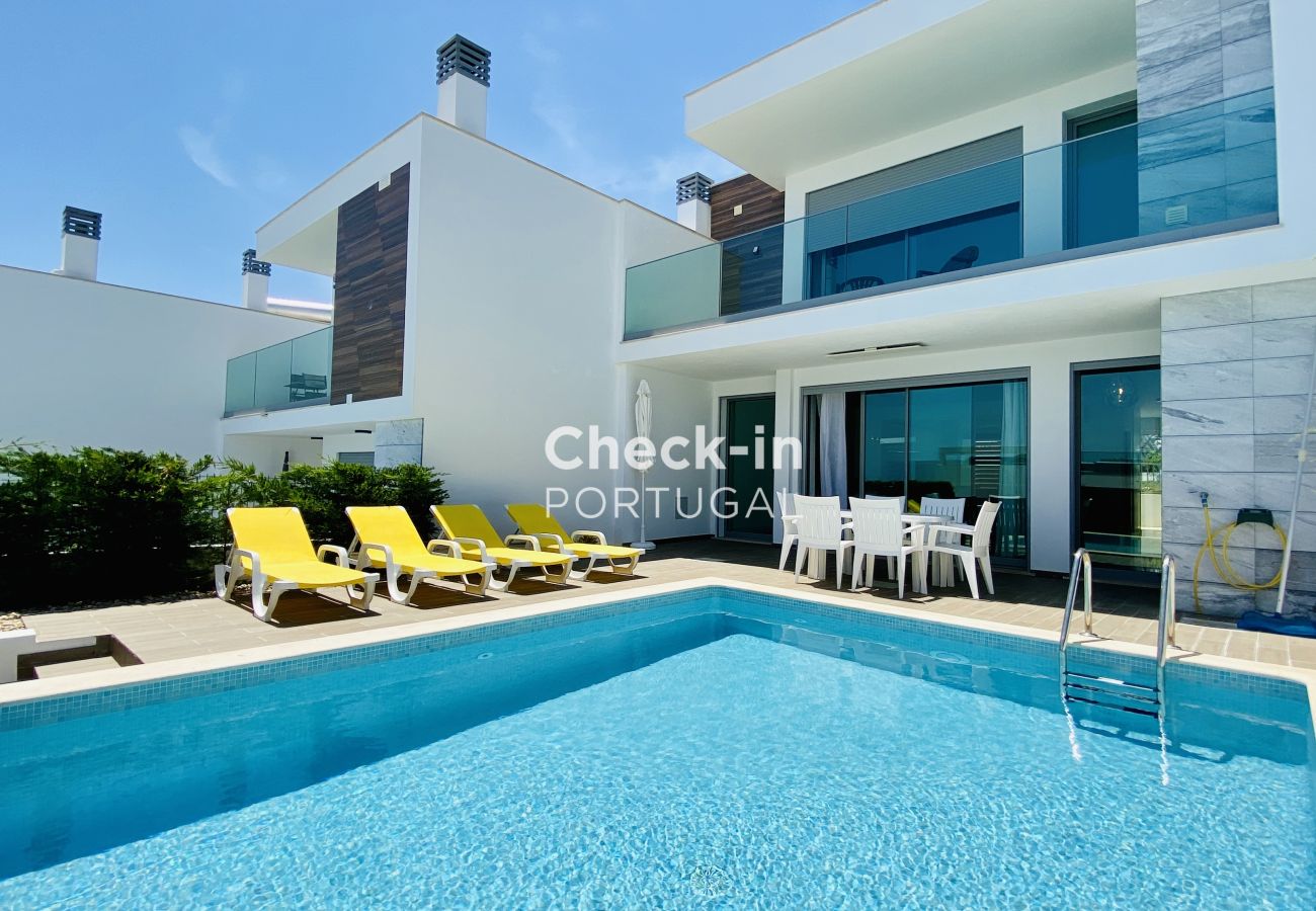 Exterior of a private house with a pool and sun loungers